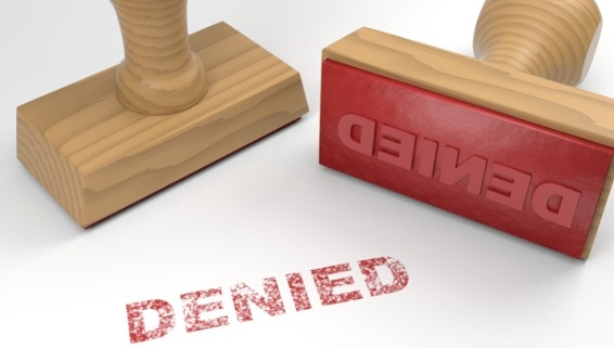 Image of two stamps. one on its side. on a paper is stamped in red in reading Denied