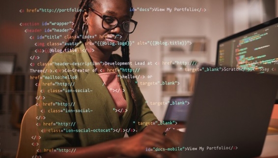 Image of woman working on computer with code overlaid on top of image