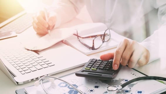 Image of man typing on calculator