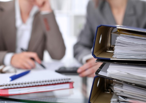 Image of binders with blurred people in the background