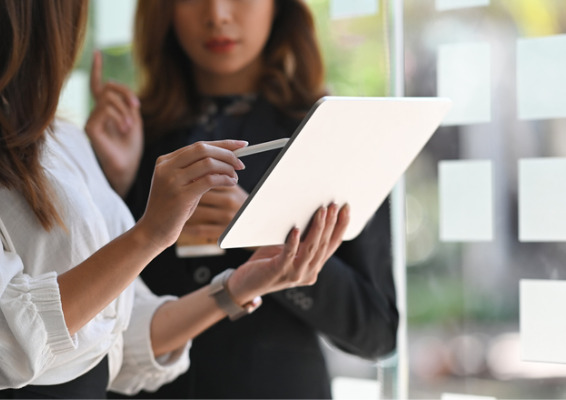 Image of two women discussing over a tablet