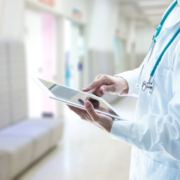 Image of doctor typing on tablet