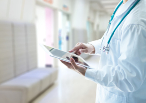 Image of doctor typing on tablet