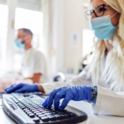 Image of lab scientist typing on a computer