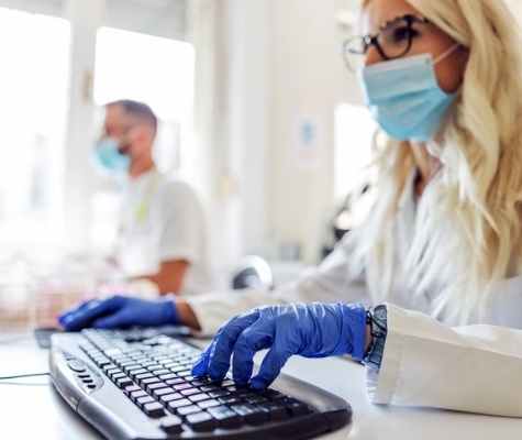 Image of lab scientist typing on a computer
