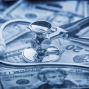 Image of stethoscope on top of twenty dollar bills