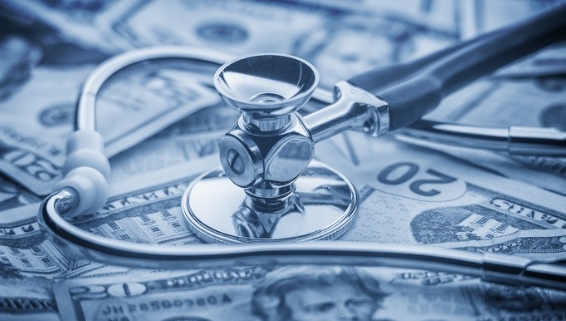 Image of stethoscope on top of twenty dollar bills